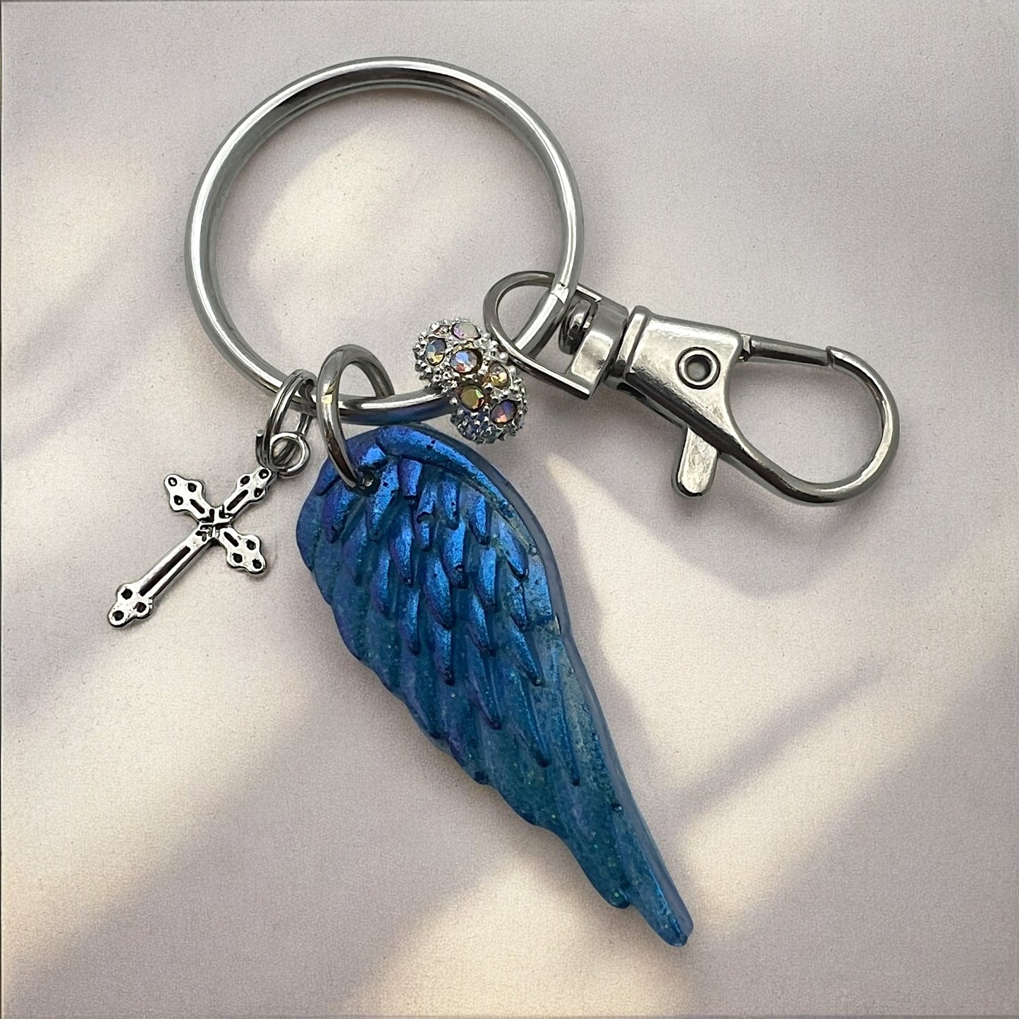 Blue Resin Angel Wing Keychain with Cross Charm and Rhinestone Bead – Inspirational Bag Charm, Purse Accessory, Memorial Gift for Her