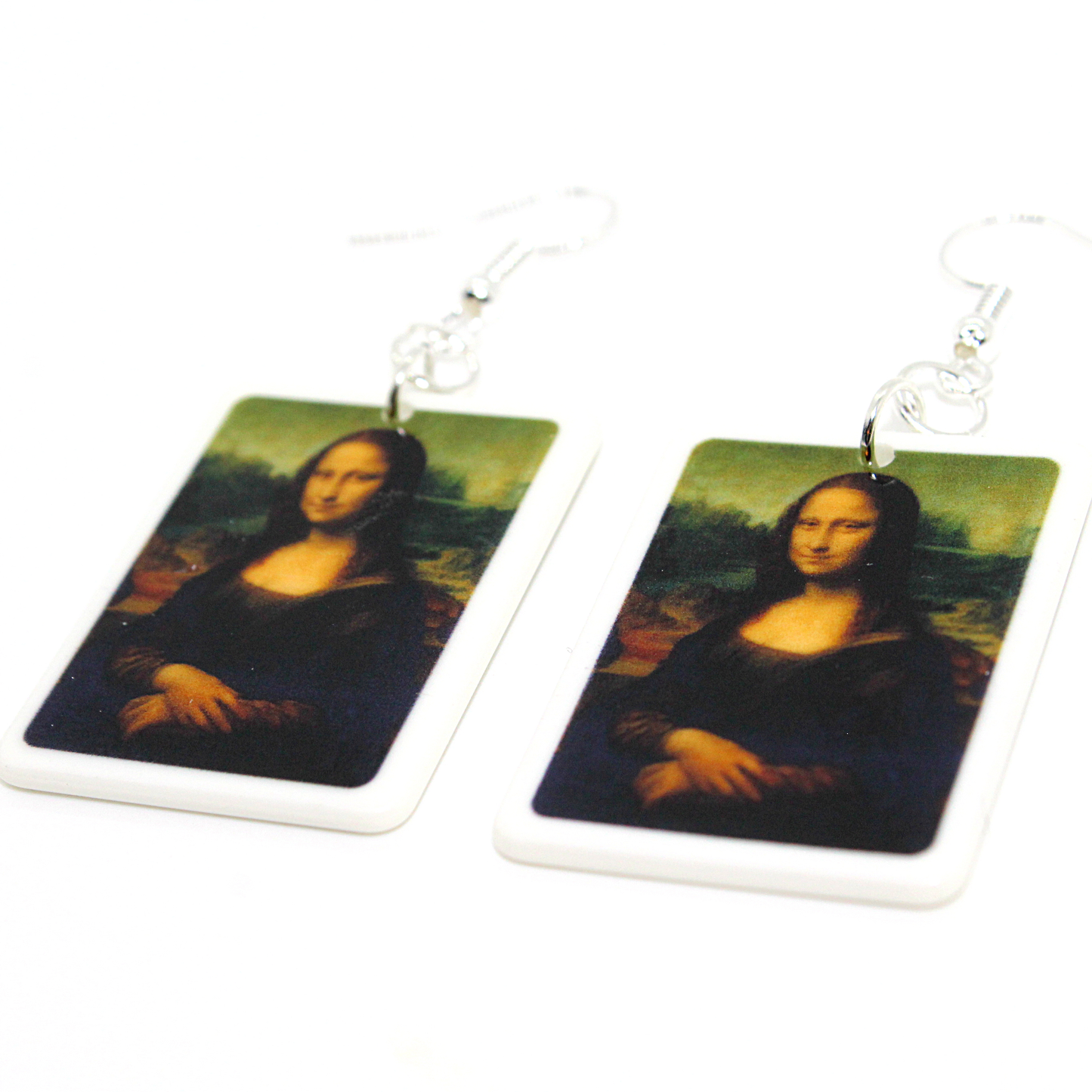 Flat lay picture of Square Acrylic Earrings of Mina Lisa Portrait Dangling from French Ear Wire Hooks