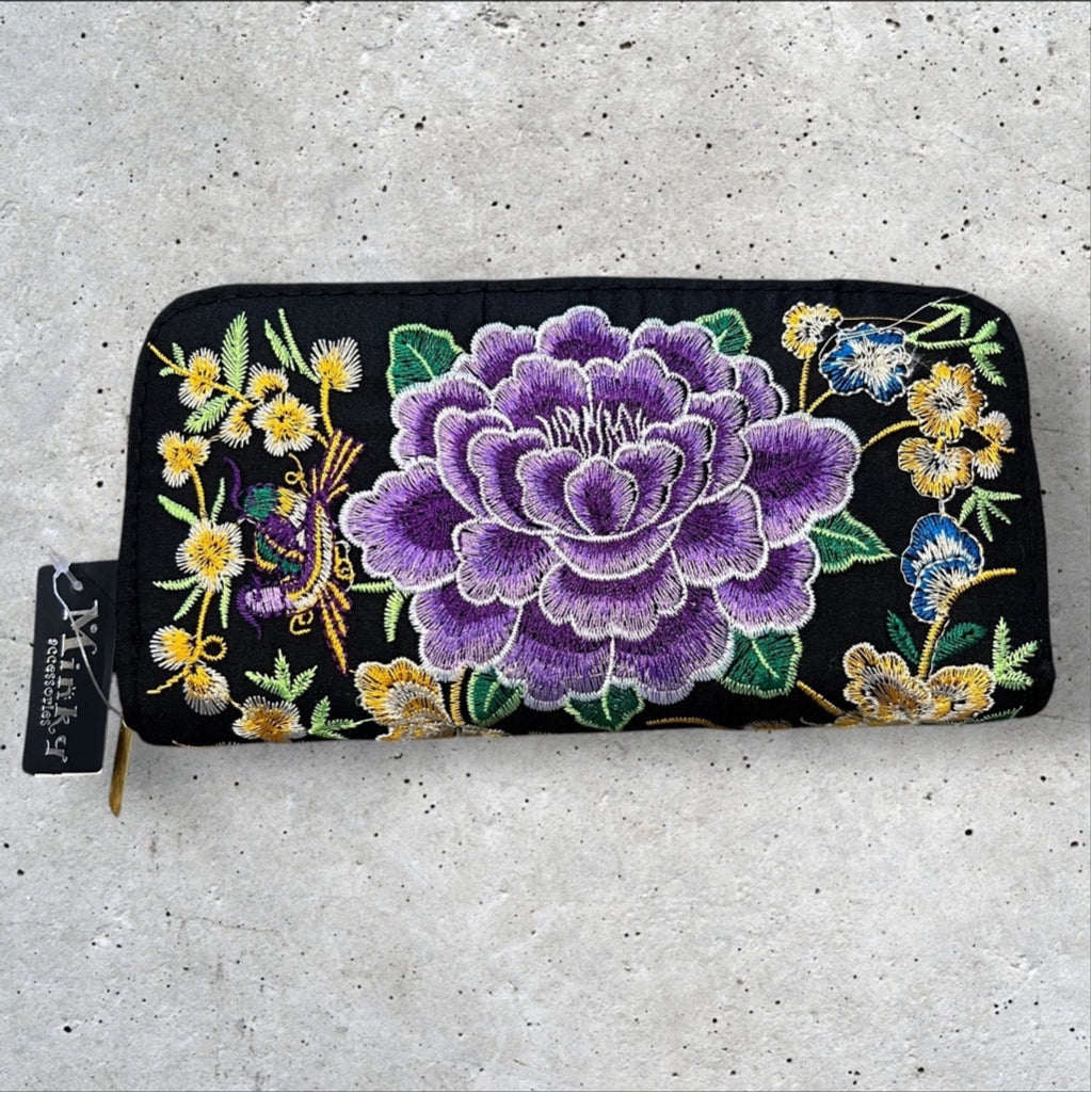 Black Fabric 8x4” zip around wallet with a vibrant purple embroidered flower and yellow embroidered flowers 