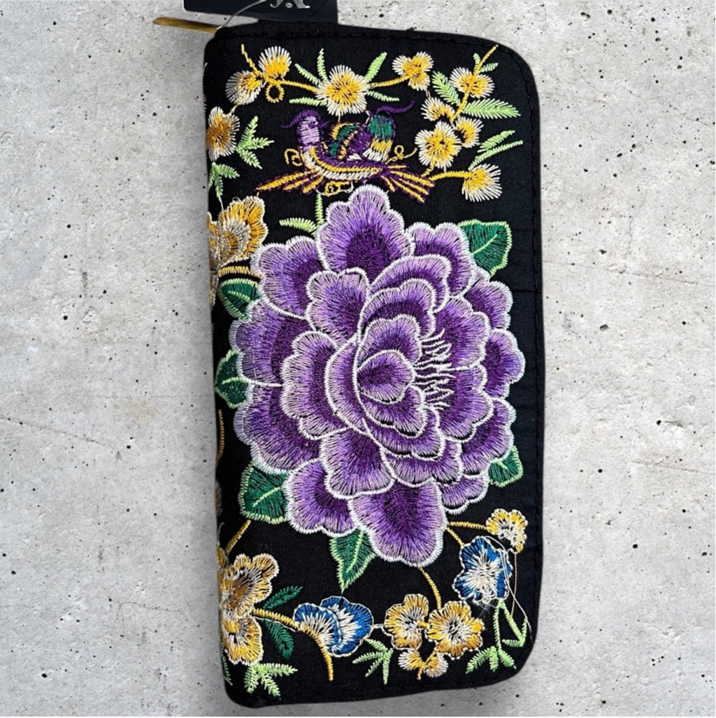 Black Fabric 8x4” zip around wallet with a vibrant purple embroidered flower and yellow embroidered flowers 